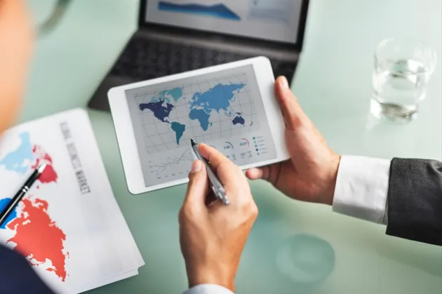 Business analyst reviewing global market data digitally