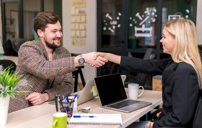 Business professionals shaking hands after meeting