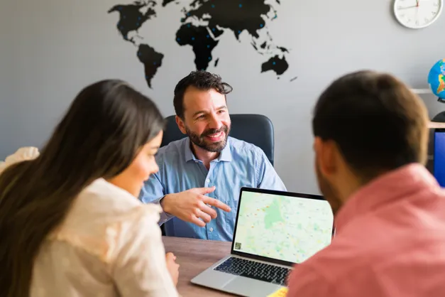 Travel agent discussing trip plans with clients